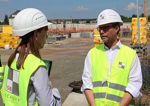 Katja Meier (Justizministerin von Sachsen) und Dirk Adams (Justizminister von Thüringen) im Gespräch beim gemeinsamen Rundgang über die Baustelle der neuen Justizvollzugsanstalt Zwickau.